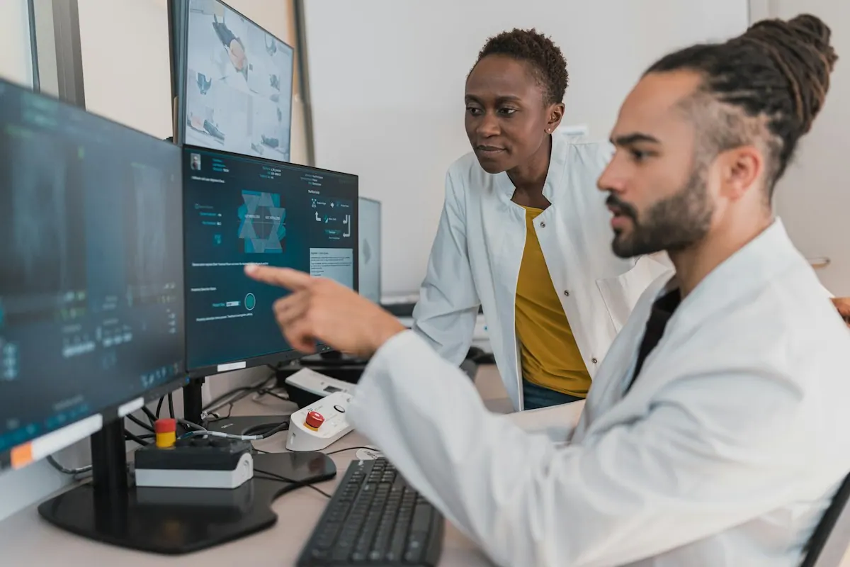 Medical coding services coder reading a signed clinical note at a workstation