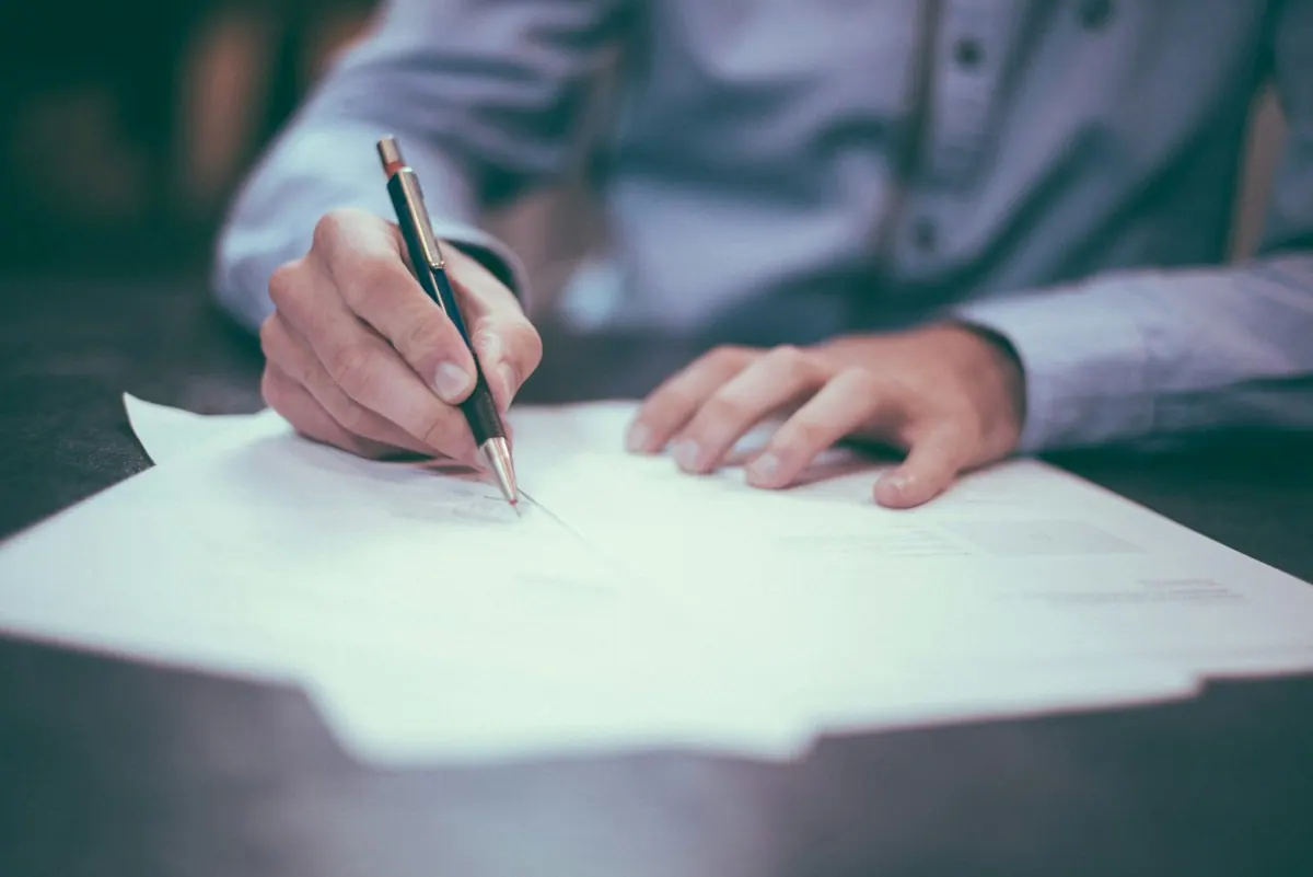 Provider credentialing and enrollment specialist signing a payer contract with a physician