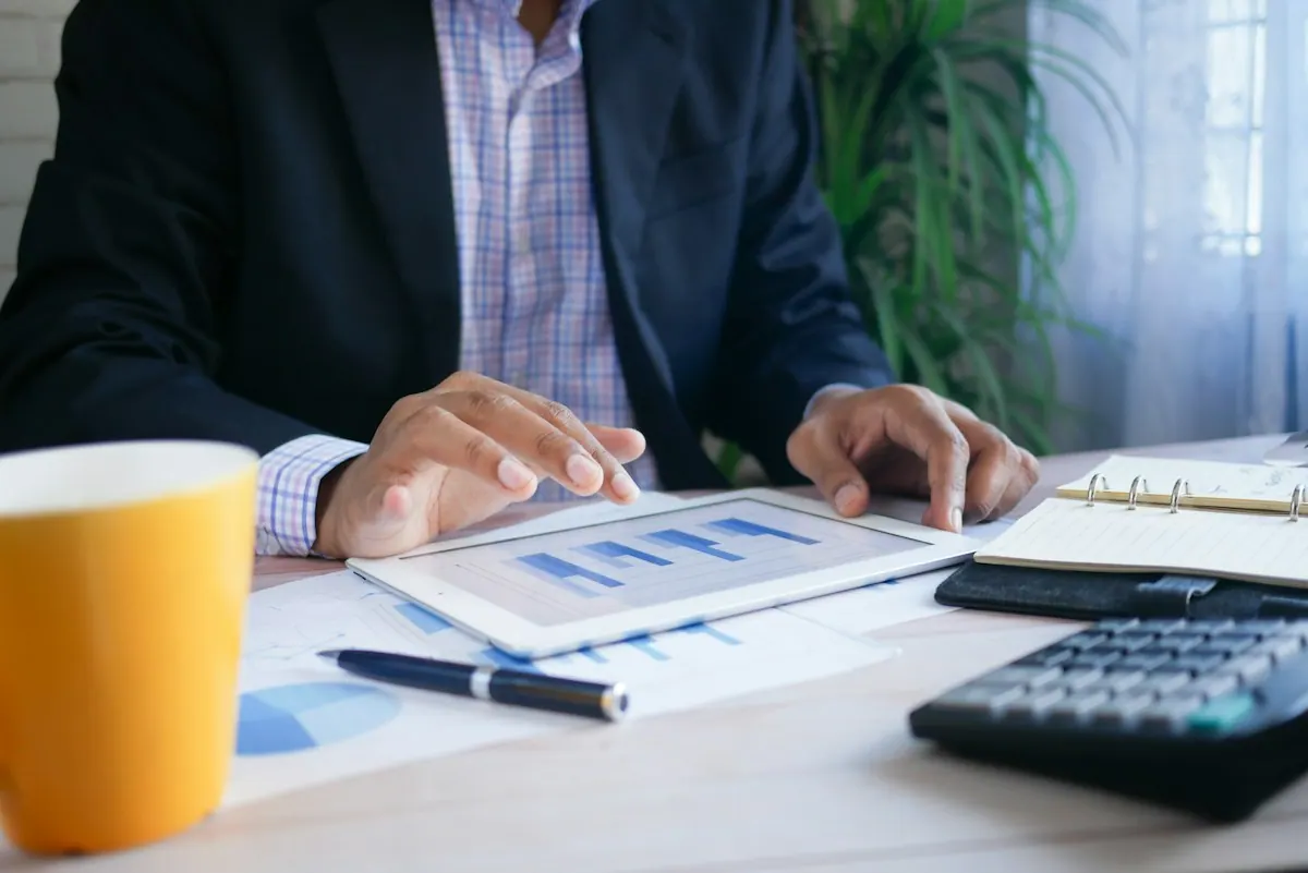 Revenue cycle management report with A/R aging and collection charts on a practice manager desk