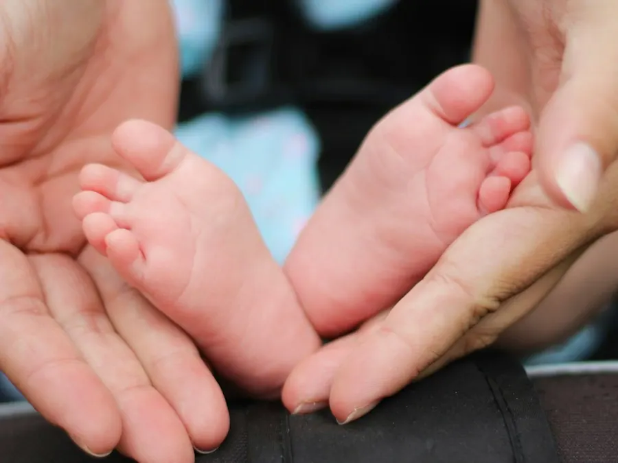 Pediatrician listening to a toddler's chest during a well visit, pediatric billing services